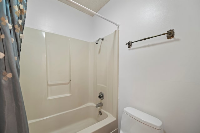 bathroom with shower / bath combination with curtain and toilet