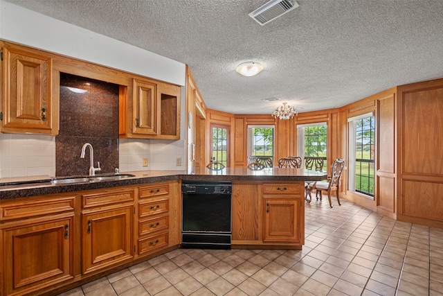 kitchen featuring a textured ceiling, black dishwasher, sink, tasteful backsplash, and light tile floors