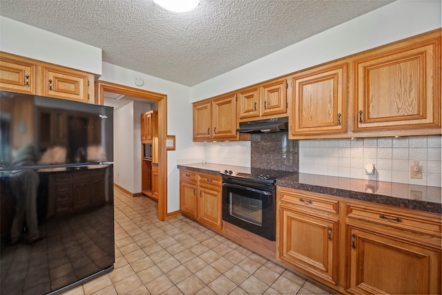 kitchen with a textured ceiling, black appliances, tasteful backsplash, and light tile flooring