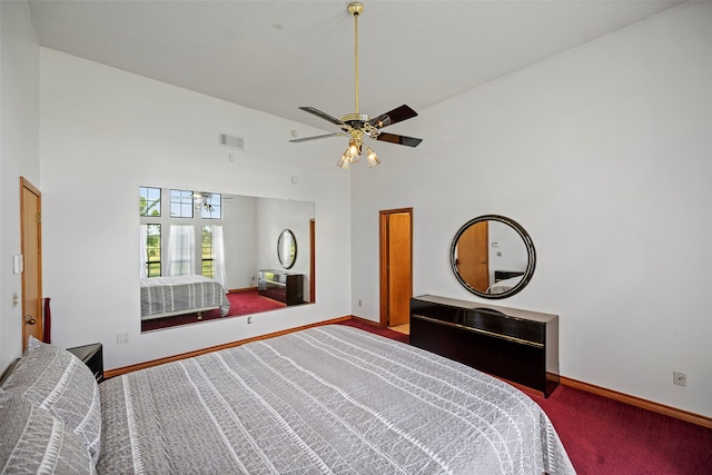 carpeted bedroom featuring high vaulted ceiling and ceiling fan