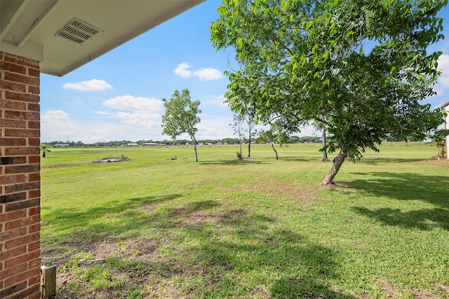 view of yard with a rural view