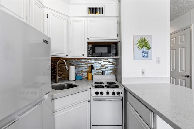 kitchen featuring light stone countertops, white appliances, backsplash, sink, and white cabinetry