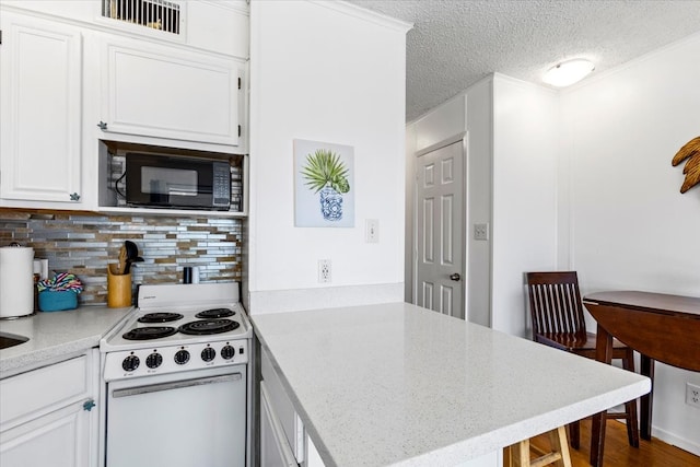 kitchen featuring tasteful backsplash, black microwave, white cabinetry, white electric stove, and a textured ceiling