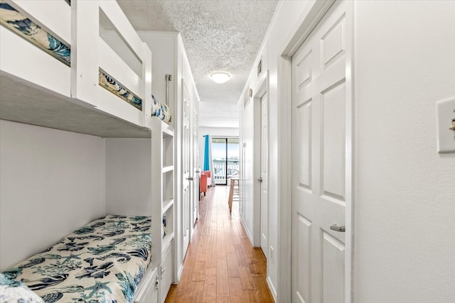 bedroom featuring hardwood / wood-style flooring and a textured ceiling