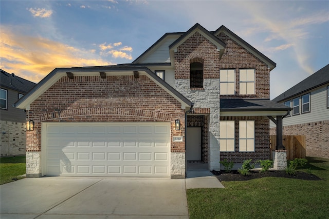 front of property featuring a garage and a lawn