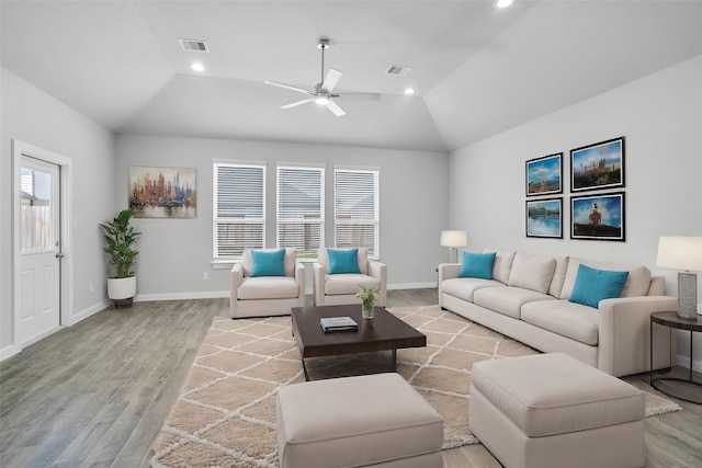 living room featuring light hardwood / wood-style flooring, lofted ceiling, and ceiling fan