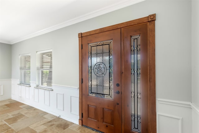 foyer featuring ornamental molding and light tile floors