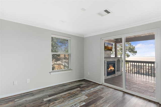 spare room with crown molding and dark wood-type flooring