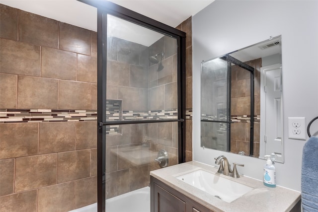 bathroom featuring shower / bath combination with glass door and vanity