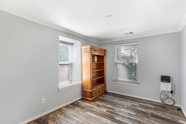 unfurnished room with a healthy amount of sunlight, ornamental molding, and dark hardwood / wood-style floors