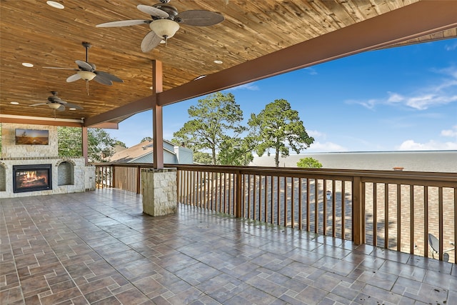 view of patio / terrace with exterior fireplace and ceiling fan