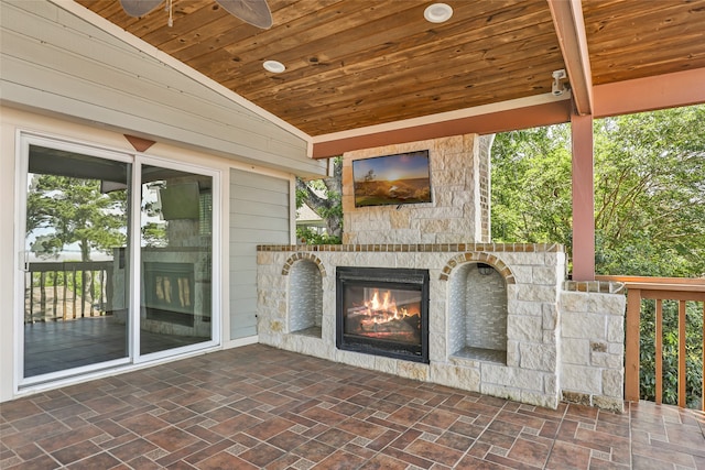 view of patio / terrace with ceiling fan and an outdoor stone fireplace