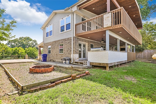 rear view of property with a patio, a deck, ceiling fan, and a lawn