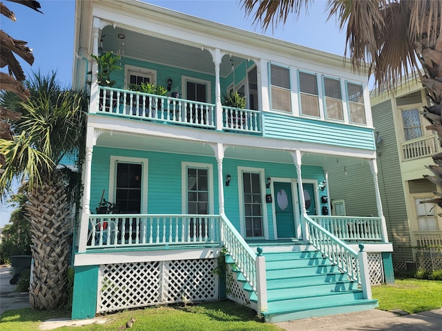 coastal home featuring a balcony and a porch