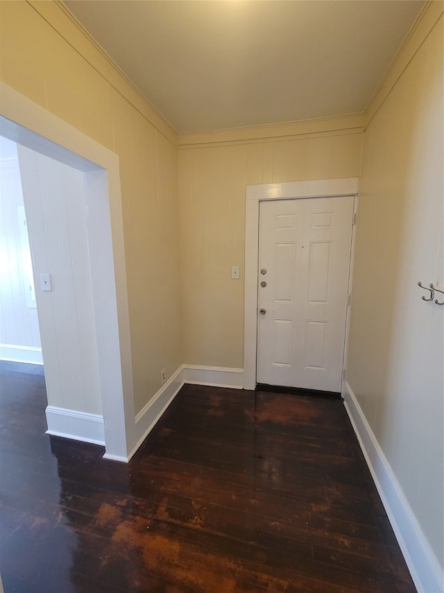 interior space with dark hardwood / wood-style floors and crown molding