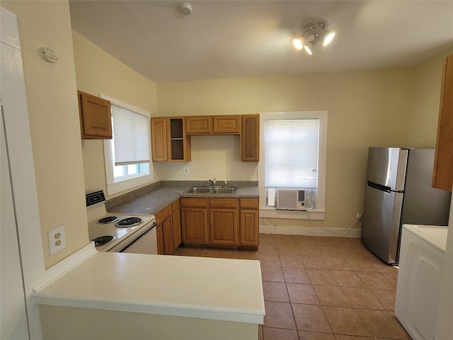 kitchen with white range with electric stovetop, light tile floors, sink, washer / clothes dryer, and stainless steel refrigerator