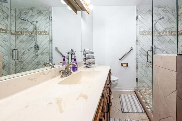 bathroom featuring tile flooring, oversized vanity, an enclosed shower, and toilet