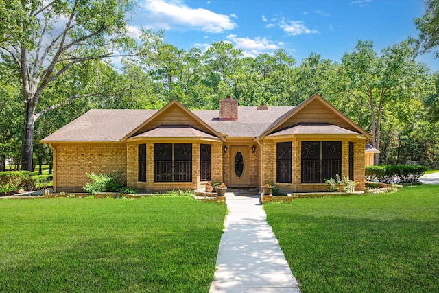 ranch-style home with a front lawn