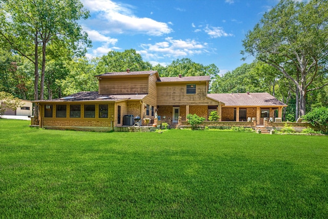 rear view of house featuring a yard