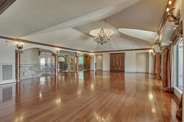 unfurnished living room with hardwood / wood-style flooring, ornamental molding, and a wealth of natural light