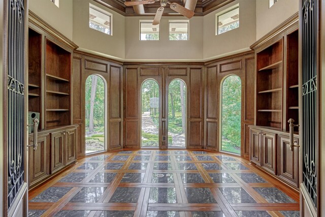 foyer with a wealth of natural light, a high ceiling, and coffered ceiling