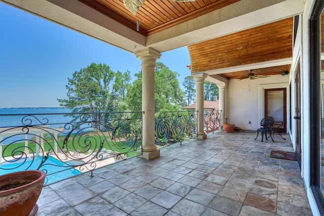 view of terrace featuring a water view and ceiling fan