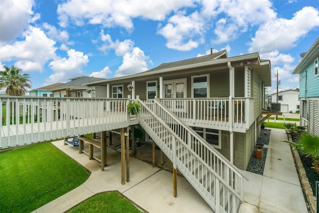 rear view of house with a deck and a patio