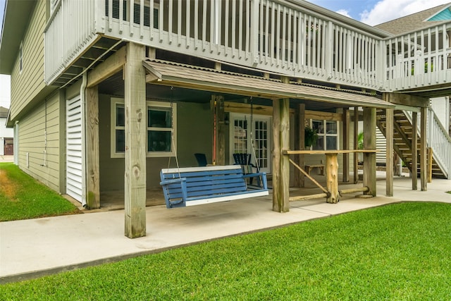 back of house with a patio, a wooden deck, and french doors