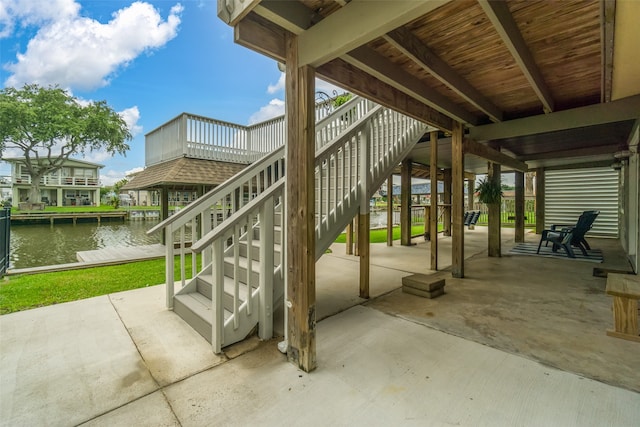 view of patio / terrace with a water view and a dock