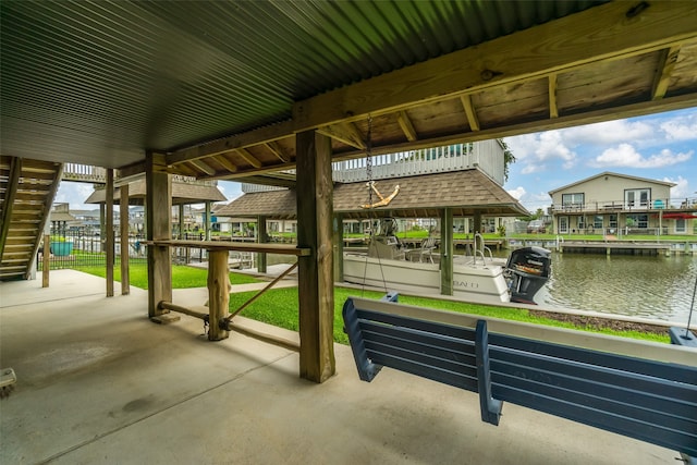 view of patio with a boat dock and a water view