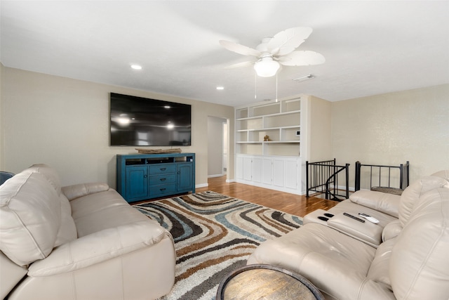 living room with ceiling fan and hardwood / wood-style floors