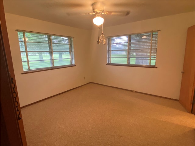 empty room featuring carpet flooring and ceiling fan