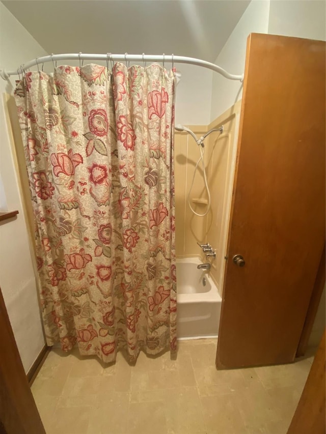 bathroom with shower / bathtub combination with curtain