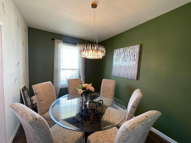 dining room featuring hardwood / wood-style floors and a notable chandelier