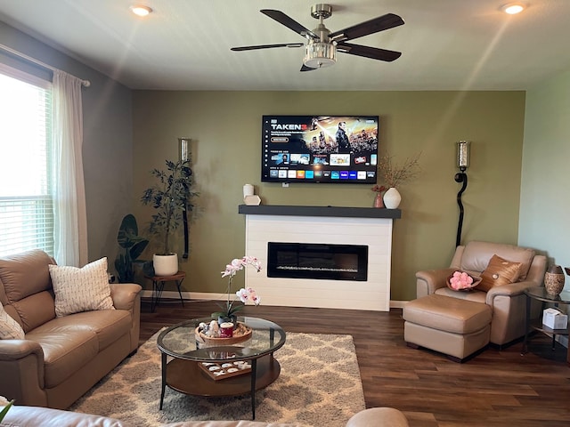 living room featuring dark hardwood / wood-style flooring and ceiling fan