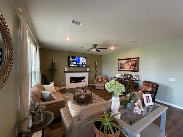 living room with dark hardwood / wood-style floors and ceiling fan