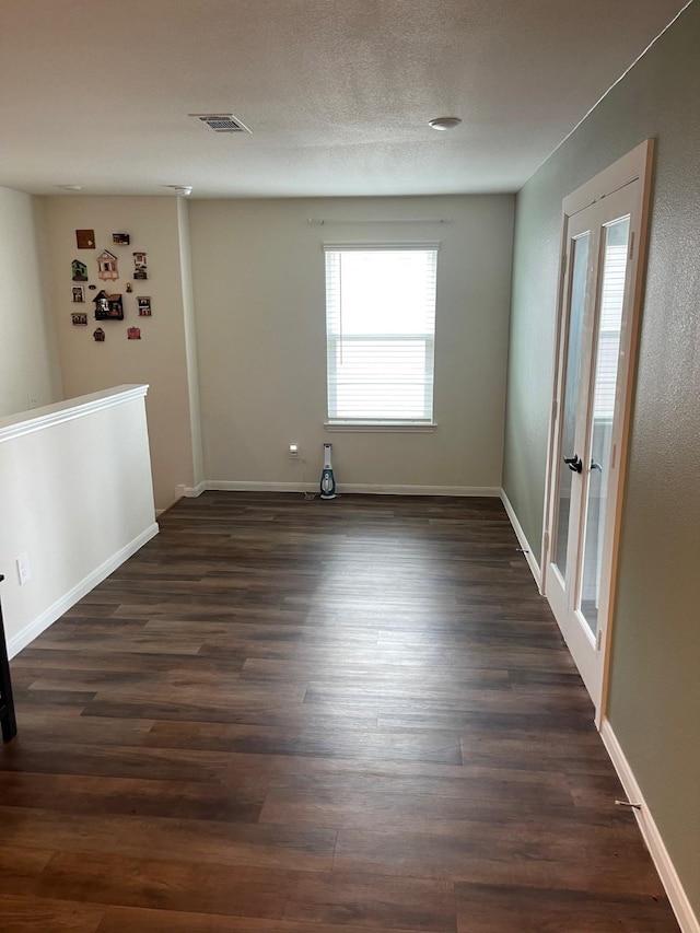 spare room featuring dark hardwood / wood-style flooring