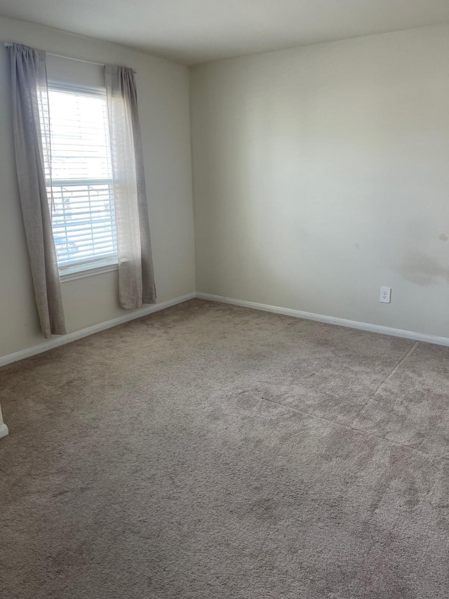 unfurnished room with light colored carpet