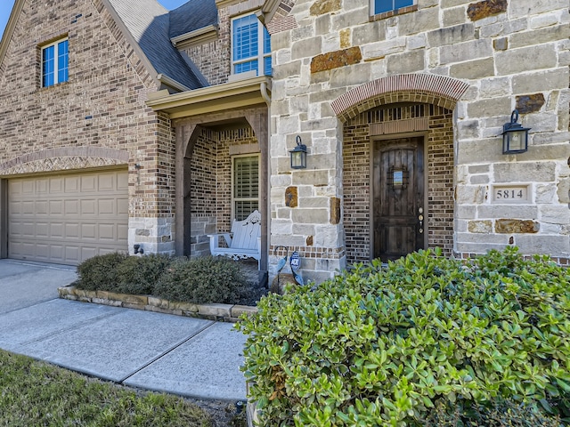 view of exterior entry with a garage