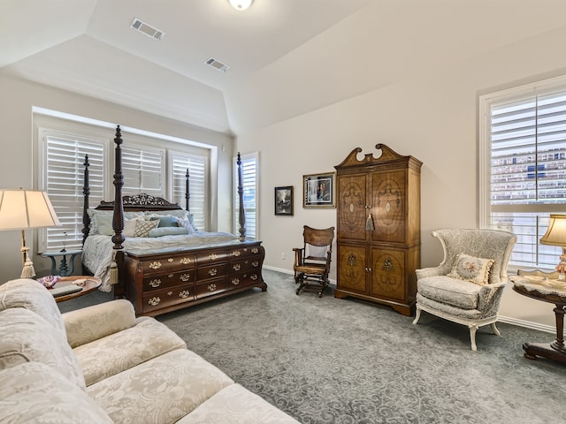 carpeted bedroom featuring multiple windows and lofted ceiling