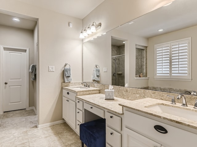 bathroom featuring tile patterned floors, vanity, and a shower with shower door