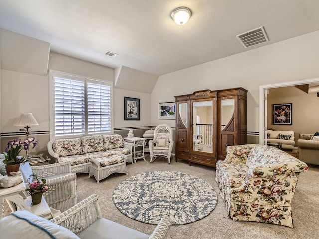 living room featuring carpet and lofted ceiling