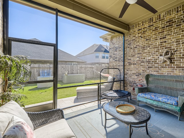 sunroom featuring ceiling fan