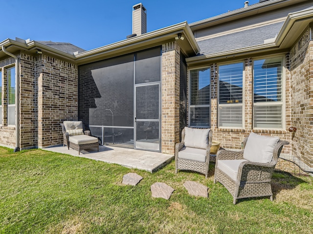 back of house with a sunroom, an outdoor living space, a patio area, and a yard