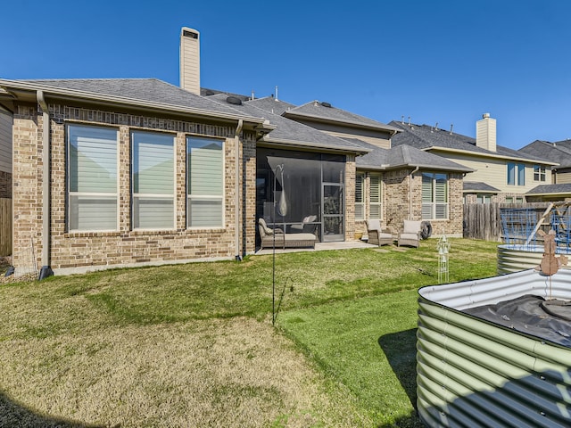 back of house featuring a patio and a lawn