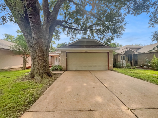 view of front of property featuring a garage and a front yard