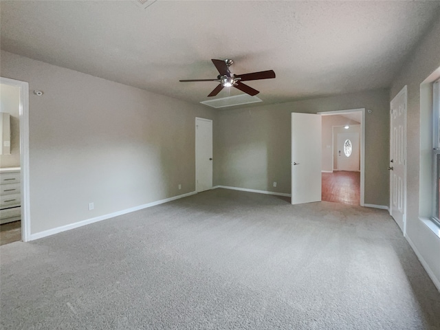 unfurnished bedroom featuring ceiling fan, ensuite bathroom, and carpet floors