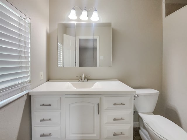 bathroom featuring vanity and toilet