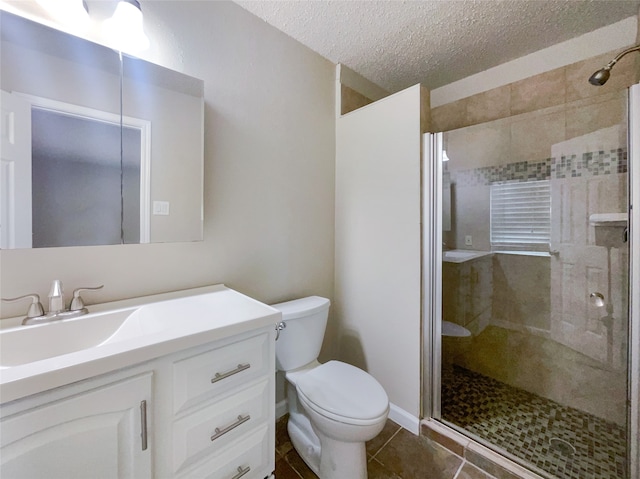 bathroom featuring oversized vanity, a shower with door, a textured ceiling, tile floors, and toilet