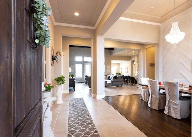 entrance foyer with crown molding and light hardwood / wood-style floors